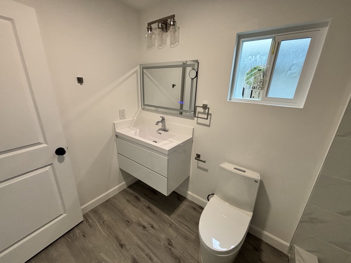 Floating vanity with lit mirror